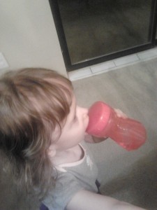 Julie drinking from a sippy cup
